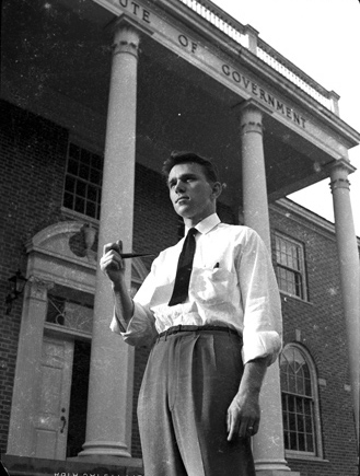UNC-Chapel Hill student smoking a pipe in front of the Institute of Government building, ca. 1940-1942