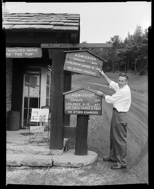 Joe Lee Hartley Jr. at Grandfather Mountain, NC changing admission sign