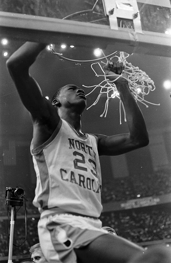 University of North Carolina Tar Heels men's basketball player Michael Jordan cutting basketball net after winning the 1982 NCAA championship.