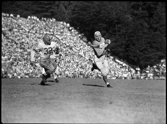 Art Weiner (#50) with ball; NC State Full Back Paul Bruno (#32).