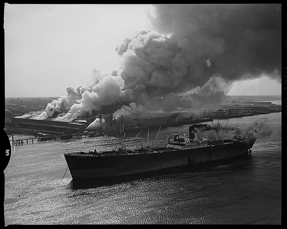 View of Wilmington Terminal Warehouse fire, with ship Max Manus in foreground.