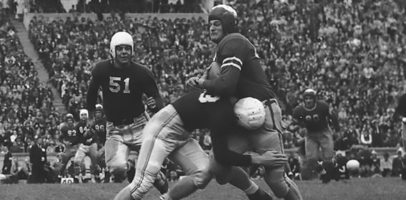 "Fritchitt of State tackled hard just after catching pass," as captioned and cropped in the 1942 Yackety Yack.
