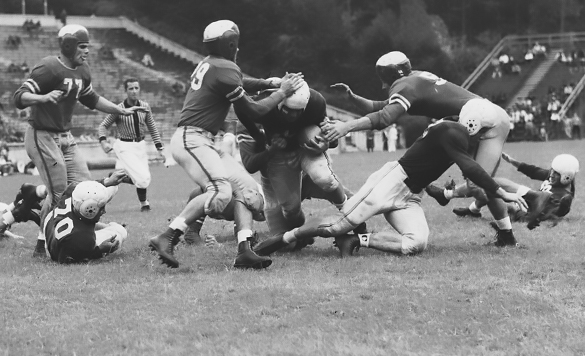 "BUILDUP TO AN AWFUL LETDOWN—"Shot" Cox plunges over the in the first quarter of yesterdays's fiasco for the only Tar Heel tally, as Caton (77), Watts (29) and Stilwell try futilely to stop the Blonde Bombshell. Hodges, Heymann, Suntheimer and Dunkle are in on the play.