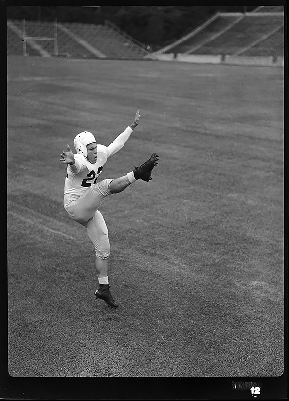 Charlie Justice photograph of Charlie Justice in a posed portrait while punting, circa 1946-1947.