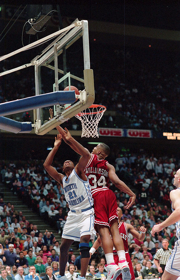 North Carolina's Donald Williams (#21) and Arkansas' Corliss Williamson (#34) battle under the basket during the East Regional Semifinal at 1993 NCAA tournament in East Rutherford, New Jersey.
