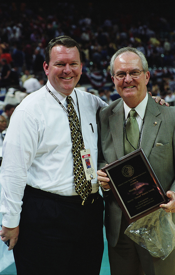 Tar Heel Sports Network play-by-play announcer Woody Durham (right) with son Wes Durham (play-by-play announcer for Georgia Tech) after receiving Marvin "Skeeter" Francis Award at 2002 ACC basketball tournament, Charlotte, NC.