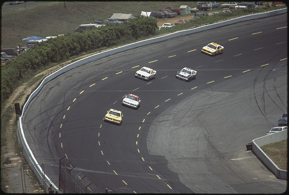 The next slide, #18, shows the yellow Wrangler car with a wider lead on Neil Bonnett.  The following cars are number 7, 28, and 17.