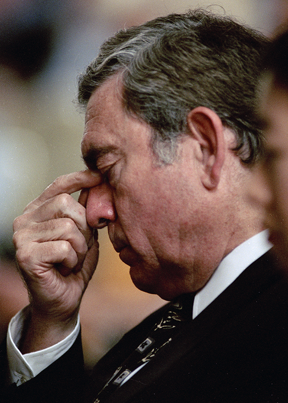 As captioned in The Herald-Sun: "CBS Anchor Dan Rather bows his head during the memorial ceremony for his fellow newsman Charles Kuralt." Photograph by Bill Willcox.