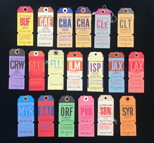 19 colorful Piedmont Airline baggage tags for various locations.