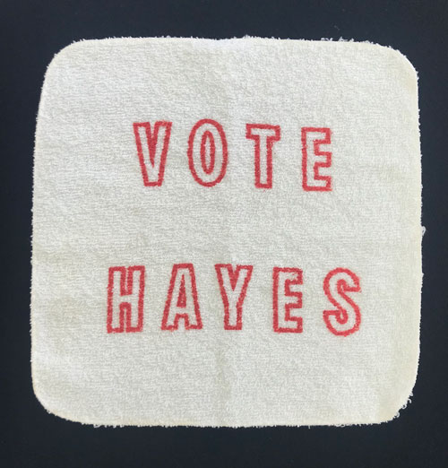 White wash cloth with words "Vote Hayes."