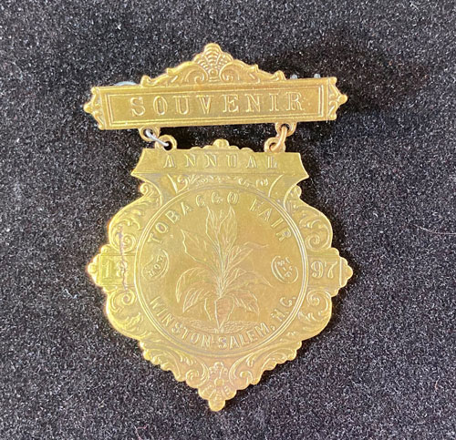 Gold medal with the words "Souvenir" and "Tobacco Fair"