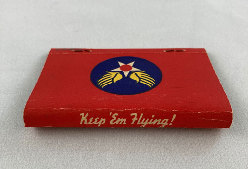 Edge of a matchbook with words "Keep 'em flying!"