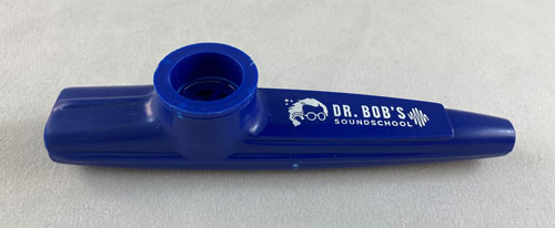 Blue kazoo with drawing of a person's hair and glasses and the words "Dr. Bob's Sound School."