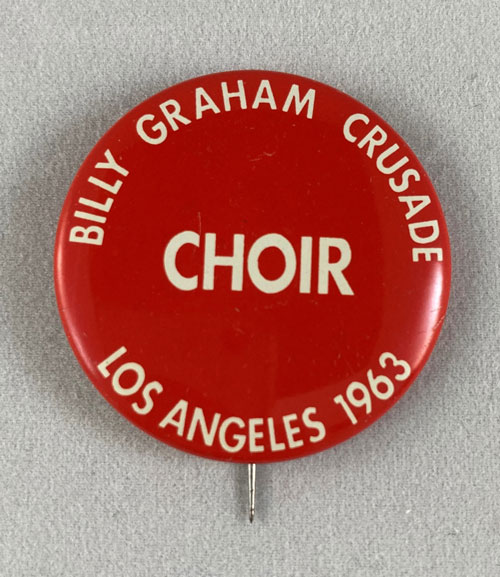 Red pinback with the words and phrases "Billy Graham Crusade," "Choir," and "Los Angeles 1963."