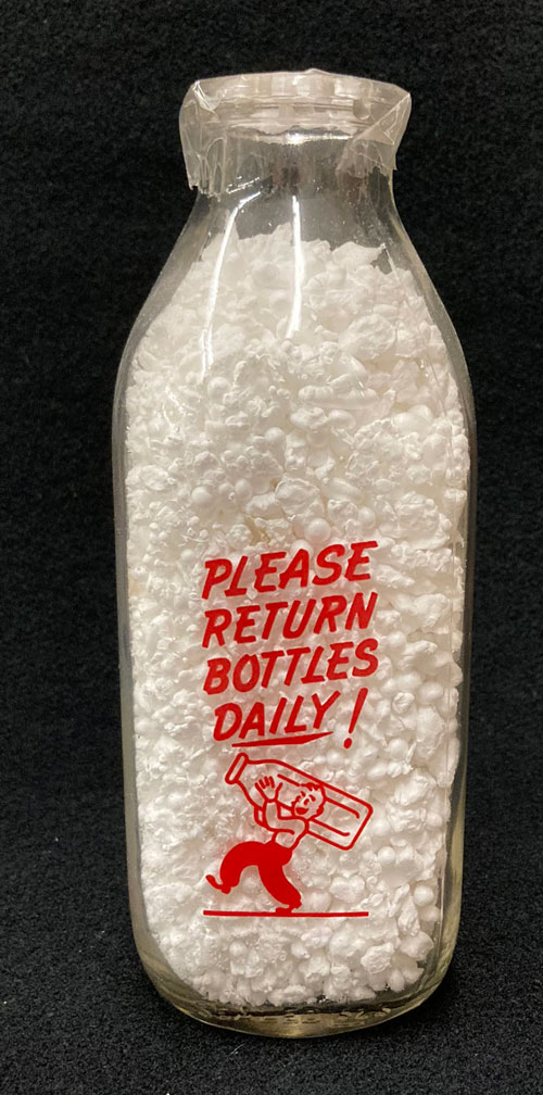 A second side of one-quart milk bottle with the words "Please Return Bottles Daily," and an image of a man carrying a large milk bottle on his back.