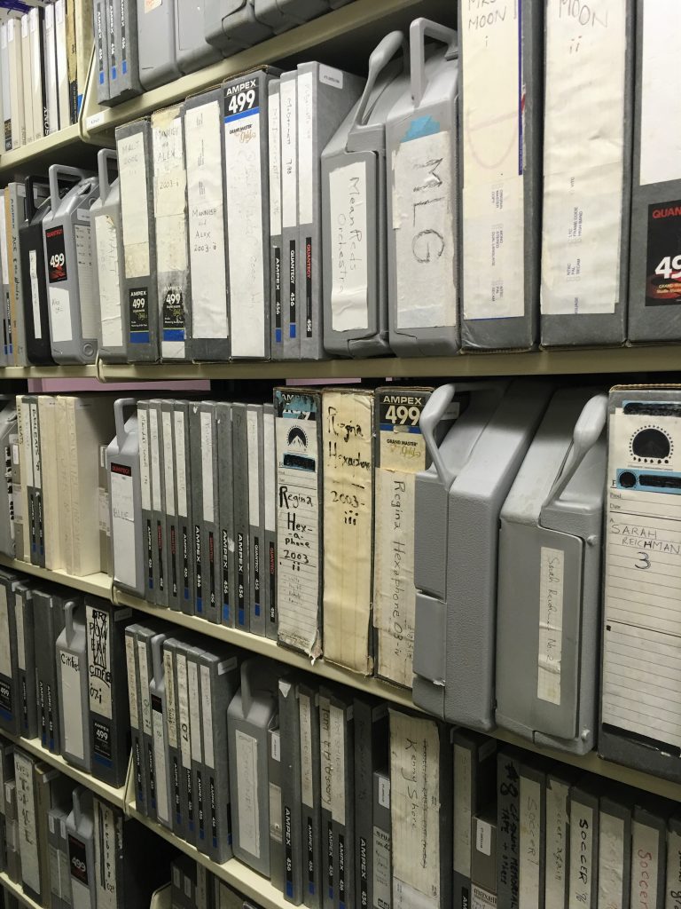 A selection of audio recordings found in the Duck Kee Studio Collection (20553) at the SFC. Recordings are pictured in the vault at Wilson Library.