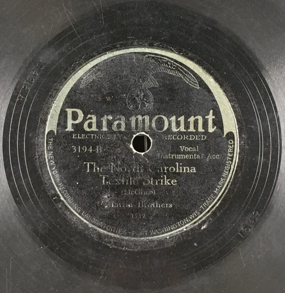 Record label for 78RPM record. Text reads: Paramount, Electrically Recorded. 3194-B. Vocal, Instrumental Acc. The North Carolina Textile Strike (McGhee). Martin Brothers. Bottom of label reads: "The New York Recording Laboratories - Port Washington, Wis-Trade Mark Registered."