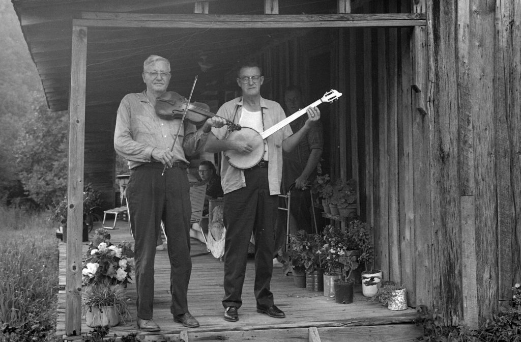 black and white photo of Tommy Jarrell and Fred Cockerham on Fred Cockerham's front porch