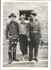 Three men standing in costume
