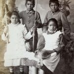 Four Pueblo students after five months at the Carlisle Indian Industrial School.