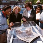 Spectators look at a  model of the Sonja Haynes Stone Black Cultural Center following ground breaking ceremonies, 2001