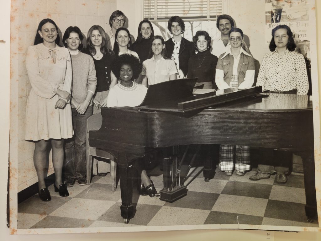 Martha Flowers at piano with group of UNC Students.