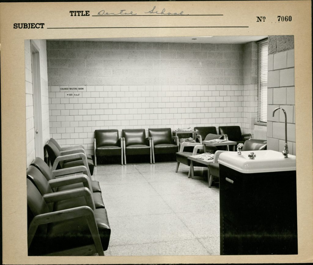 Waiting room at the UNC School of Dentistry, ca. 1950s. A sign for the "Colored Waiting Room" is visible on the back wall.